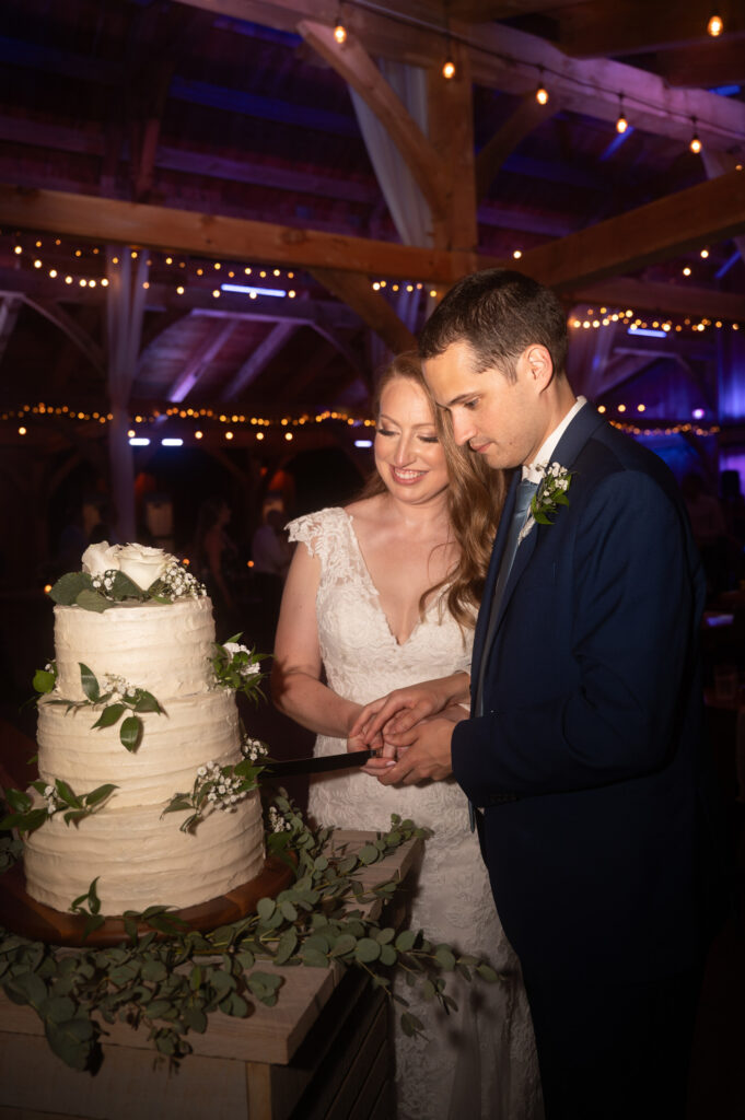 The bride and groom cutting their cake.