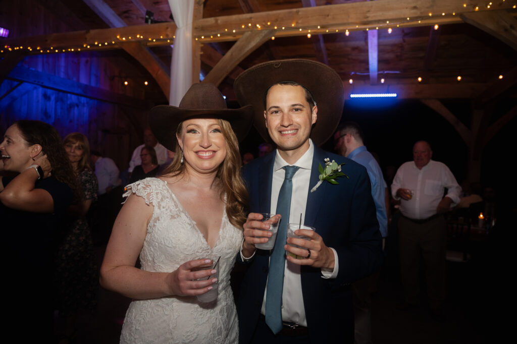 Leah & Brian in cowboy hats at the end of the night.