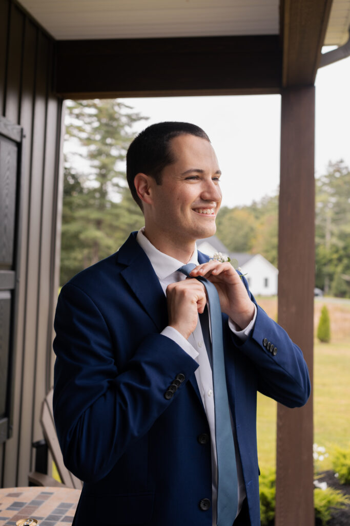 The groom adjusting his tie.