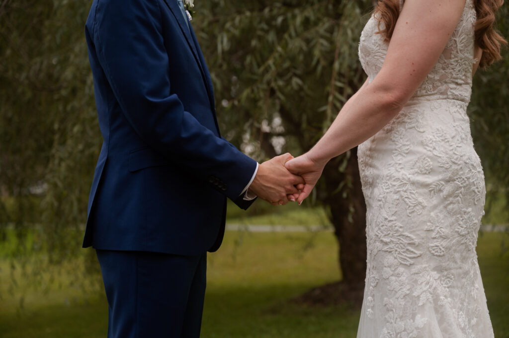 Leah & Brian holding hands after their first look.