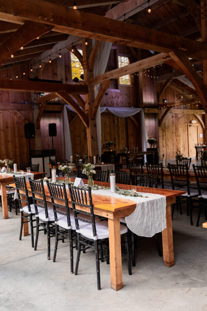 Tables and chairs decorated for Leah & Brian's September wedding at Juniper Springs Wedding Barn.