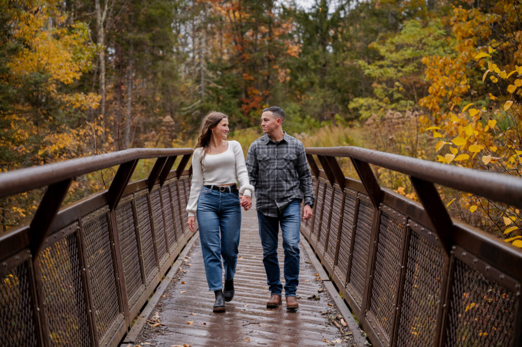 Catskills Wedding Photographer - Aubrie and Dolan walking on the bridge at Kaaterskill Falls during their engagement session in the Catskill Mountains.