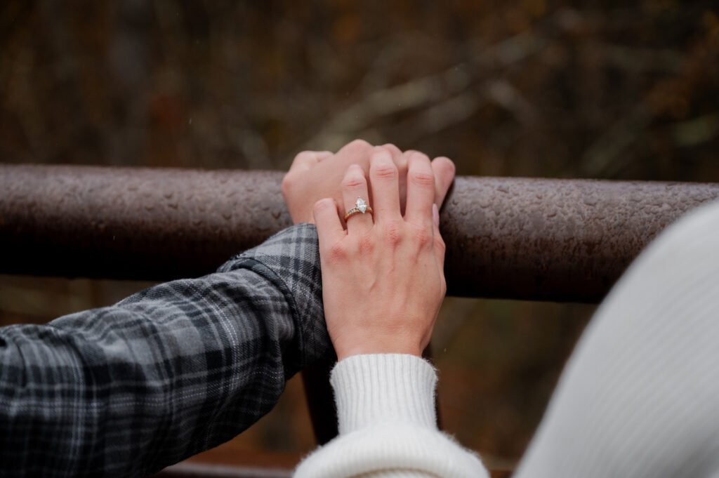 Catskills Wedding Photographer - Aubrie and Dolan holding hands on the bridge at Kaaterskill Falls during their engagement session in the Catskill Mountains.