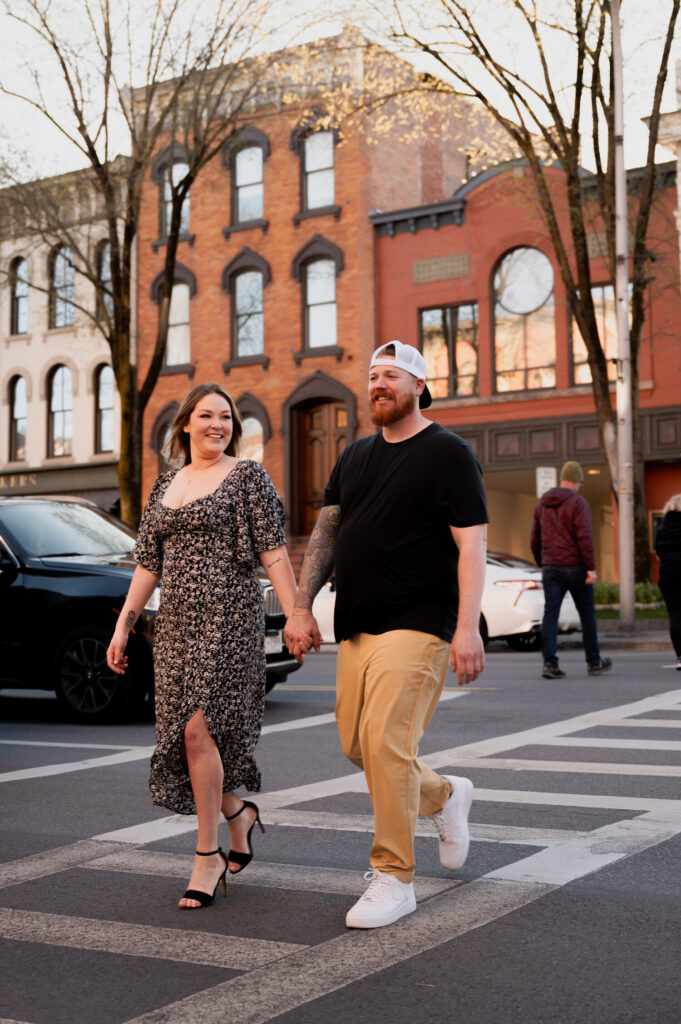 Walking through the streets of downtown Saratoga Springs during their engagement photos with Austin Ryan Photo.