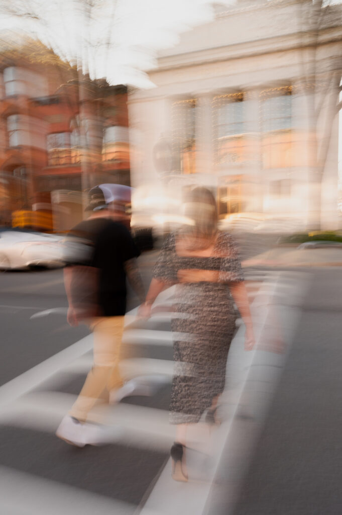 Blurry movements walking through the streets of downtown Saratoga Springs during their engagement photos with Austin Ryan Photo.