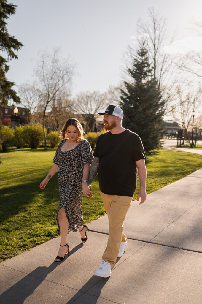 Walking through Congress Park in Saratoga Springs, NY for their engagement photos.