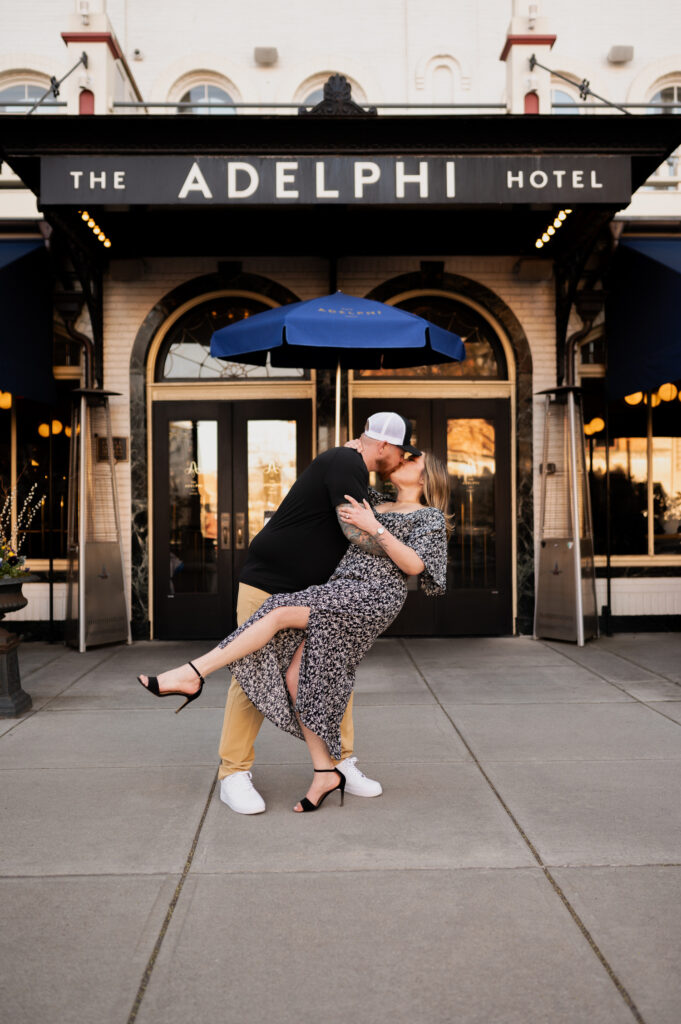 Mariah & Zac share a quick dip in front of the Adelphi Hotel in Saratoga Springs, NY during their engagement photos with Austin Ryan Photo.