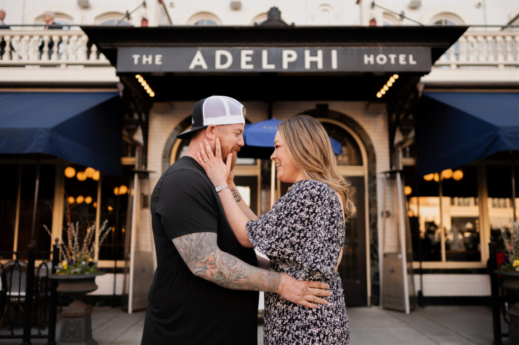 Mariah & Zac share a quick embrace in front of the Adelphi Hotel in Saratoga Springs, NY during their engagement photos with Austin Ryan Photo.