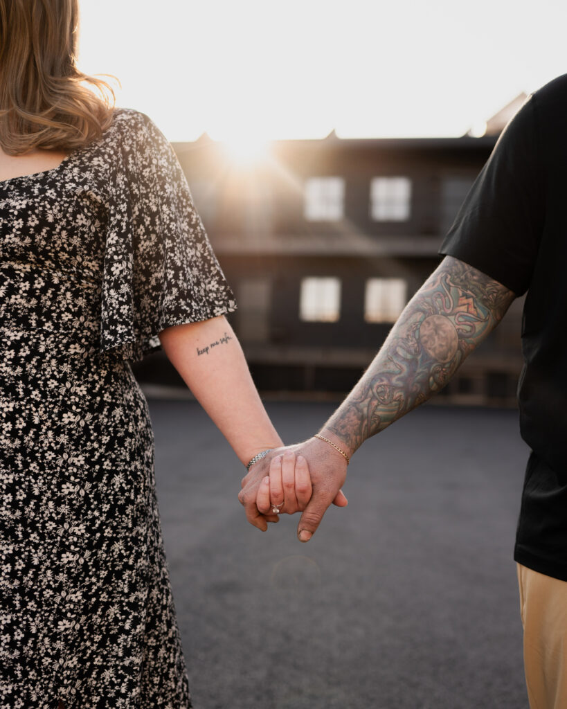 Holding hands with the golden hour sun shining down in Saratoga Springs, NY during their engagement photos with Austin Ryan Photo.