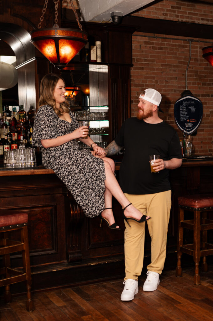 Relaxing at the upstairs bar at Harvey's Pub in downtown Saratoga Springs during their engagement photos with Austin Ryan Photo.