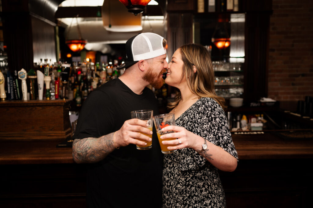 Sharing a kiss at Harvey's Pub in downtown Saratoga Springs during their engagement photos with Austin Ryan Photo.