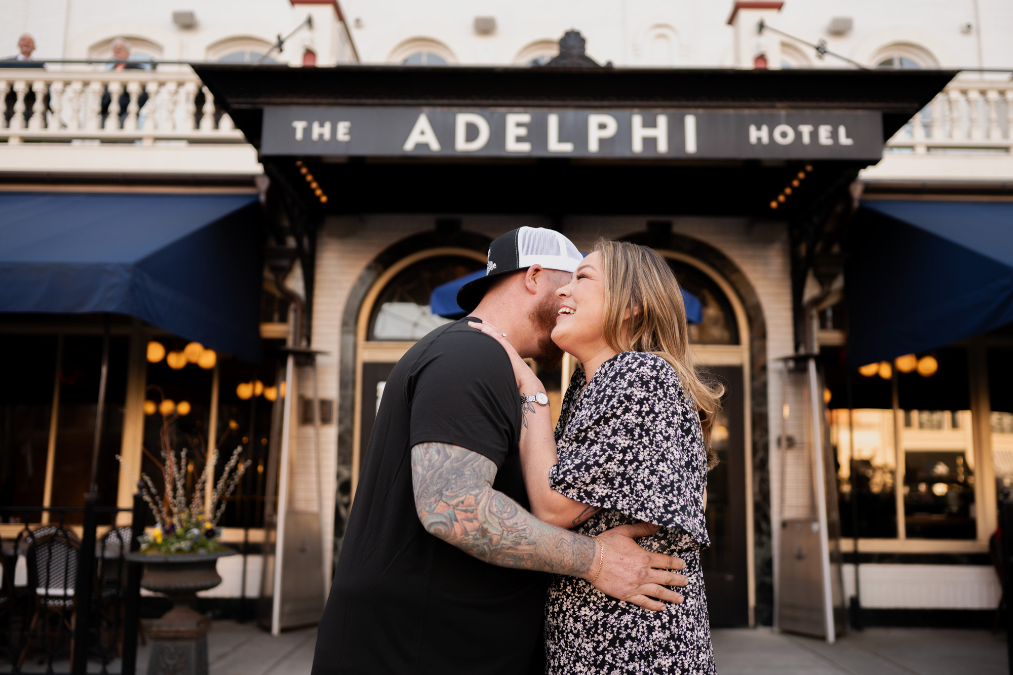 A photo in front of the Adelphi Hotel in Saratoga Springs, NY during their engagement photos with Austin Ryan Photo.