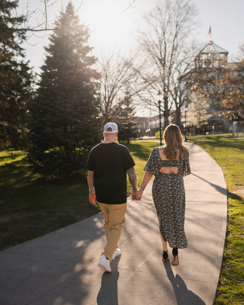 Walking through Congress Park in Saratoga Springs, NY for their engagement photos.