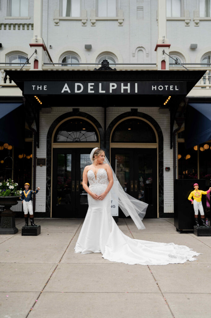 The bride poses for a portrait outside of The Adelphi Hotel in Saratoga Springs, New York.