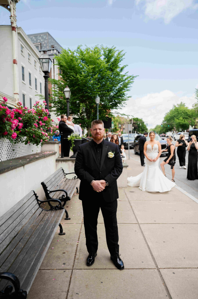 The bride gets ready for the real first look outside of The Adelphi Hotel on broadway in Saratoga Springs, New York.