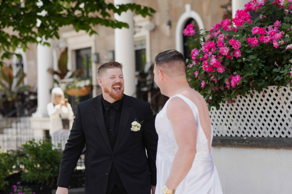 A photo of a groom surprised by his Best Man during a first look outside of the Adelphi Hotel in Saratoga Springs, New York.