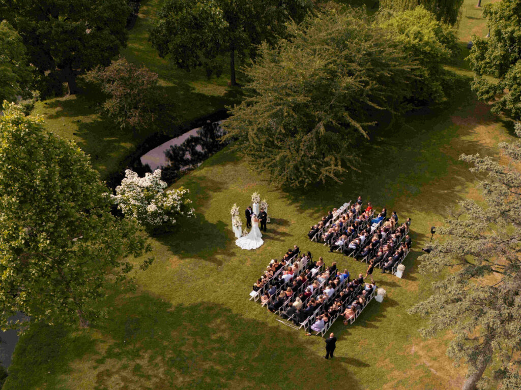 An aerial view of a romantic summer wedding in Congress Park outside of the Canfield Casino in Saratoga Springs, New York.