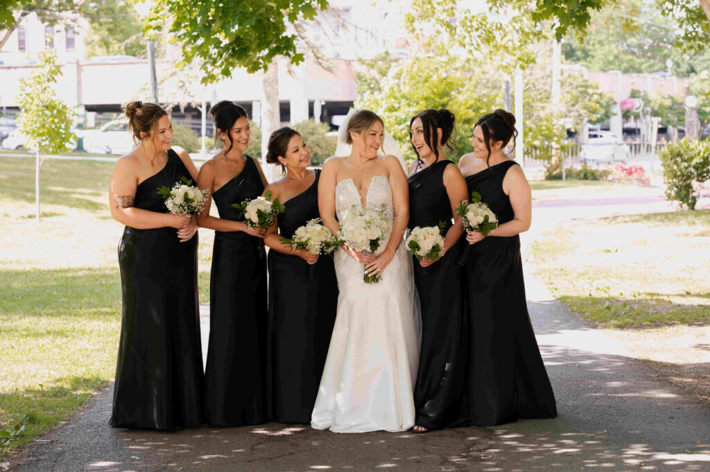 The bride and her bridesmaids share a laugh in Congress Park before their wedding at the Canfield Casino.