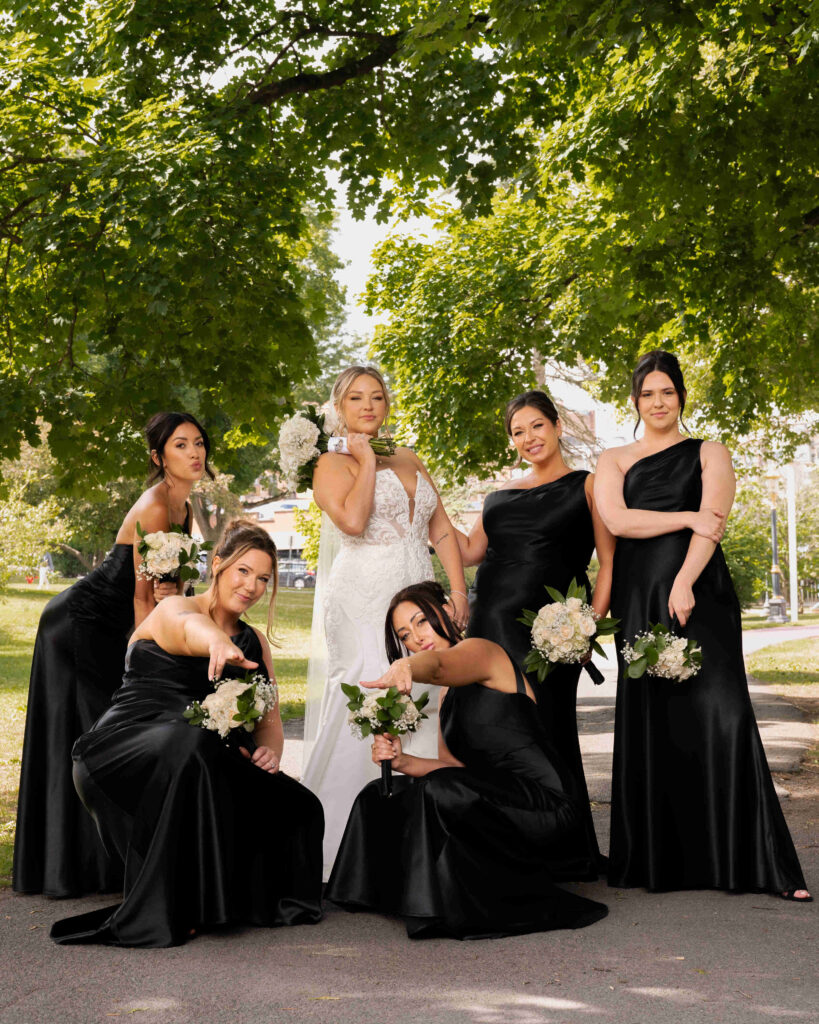 The bride and her bridesmaids pose for a photo in Congress Park before their wedding at the Canfield Casino.