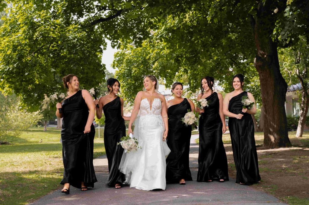 The bride and her bridesmaids share a laugh in Congress Park before their wedding at the Canfield Casino.