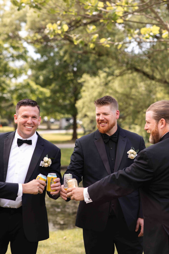 The groom and his groomsmen taking the edge off with a drink in Congress Park.