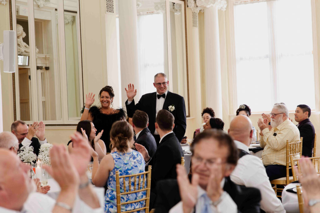 The bride's parents waving to the guests at the Canfield Casino during a wedding in Saratoga Springs, New York.