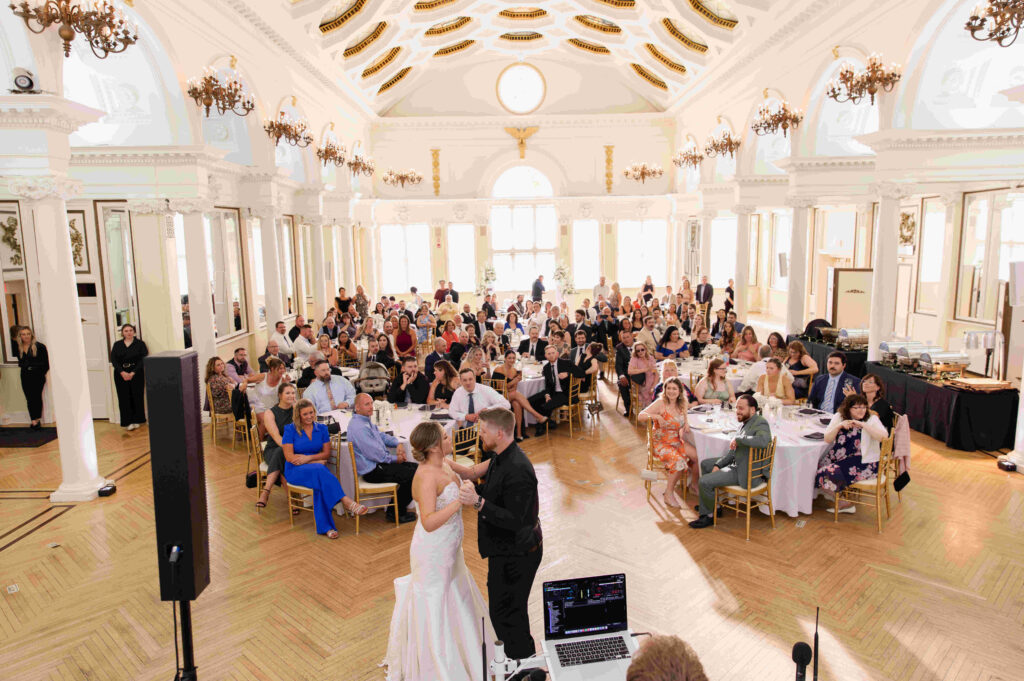 The bride and groom sharing their first dance in the ballroom of the Canfield Casino during a wedding in Saratoga Springs, New York.