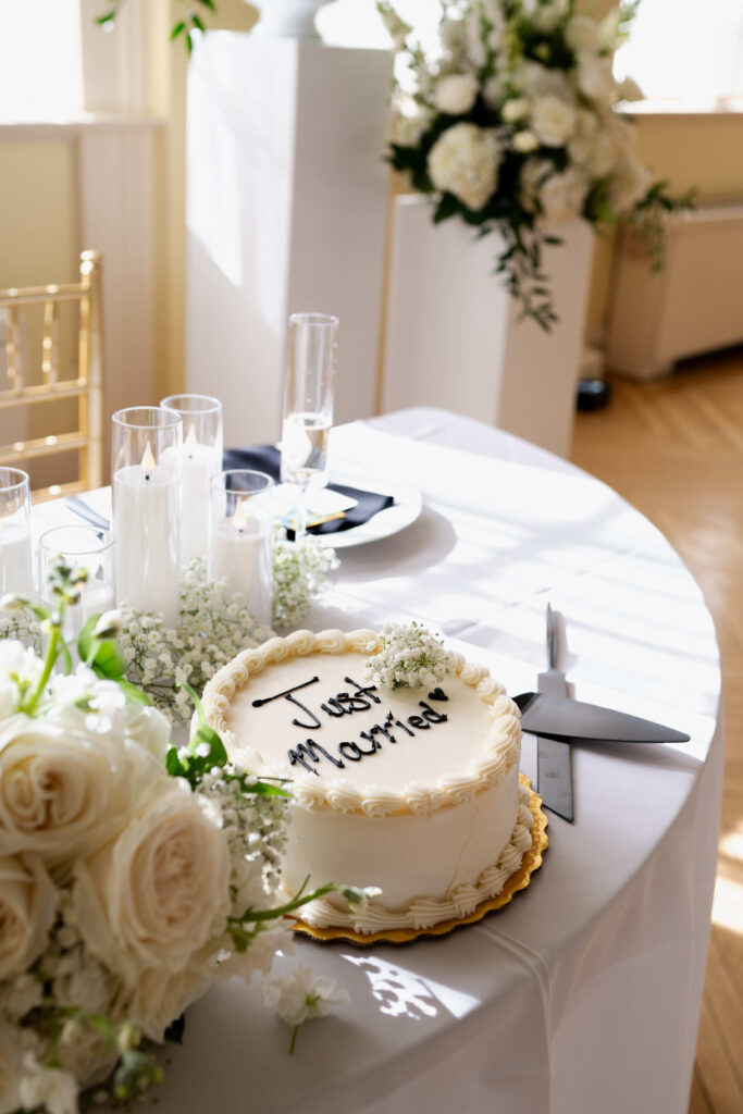 A detail photo of the wedding cake on the sweetheart table in the ballroom of the Canfield Casino.