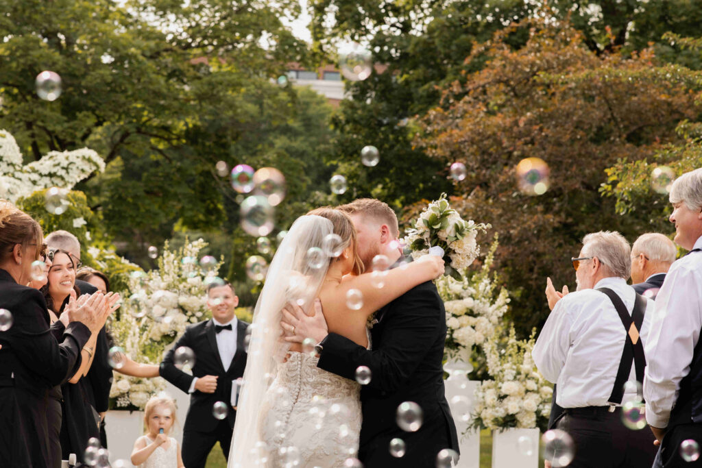 The bride and groom share a kiss after their romantic wedding ceremony in Congress Park.