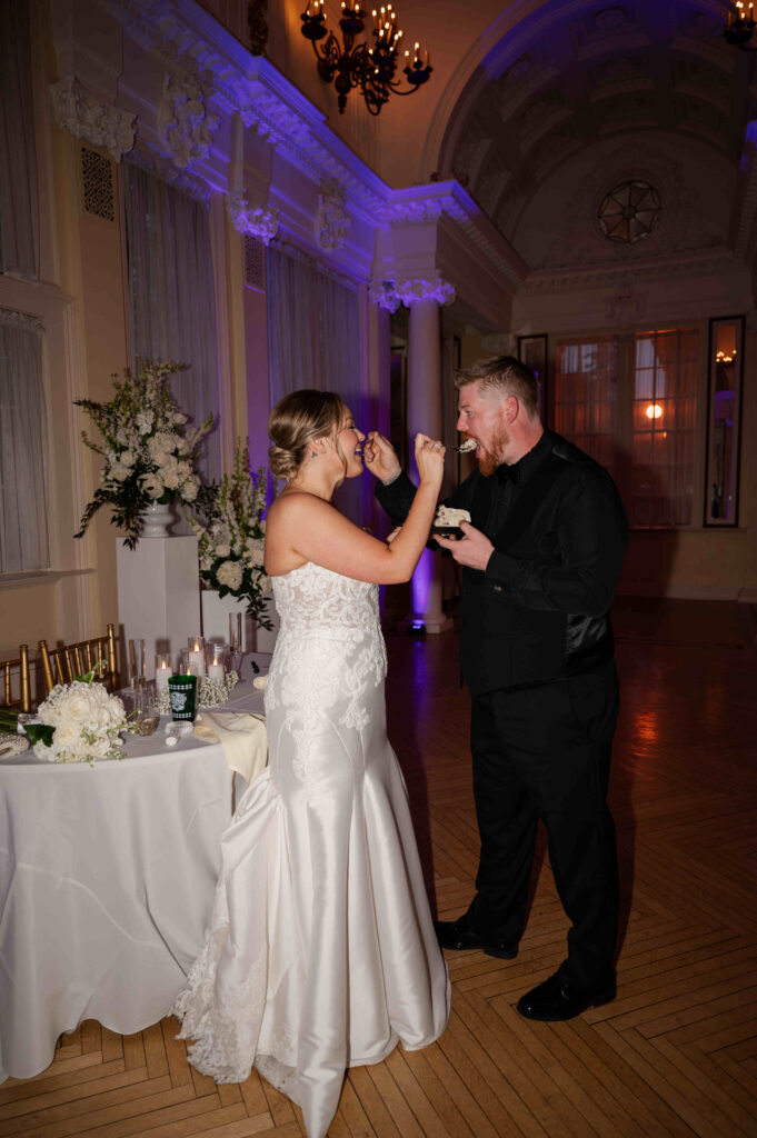 The bride and groom sharing their wedding cake at the Canfield Casino.