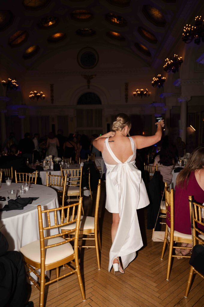 The bride making her way to the dance floor at the Canfield Casino after an outfit change.