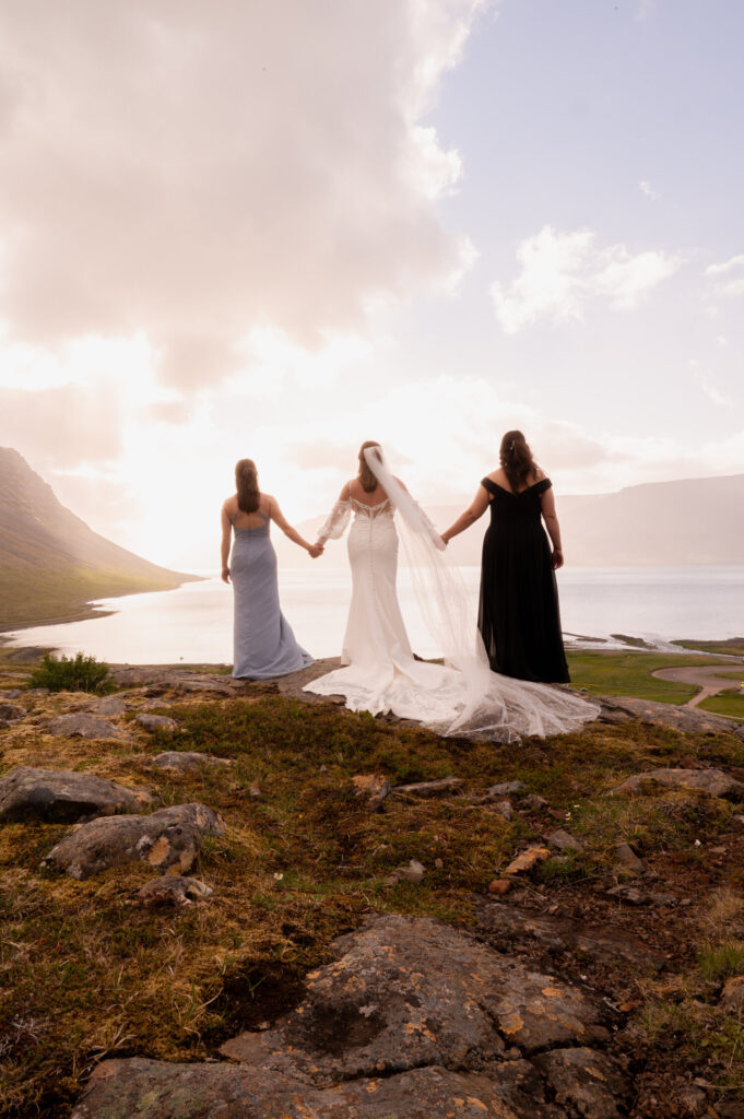 The bride and two of her bridesmaids at Dynjandi Waterfall for their Iceland destination wedding photos.