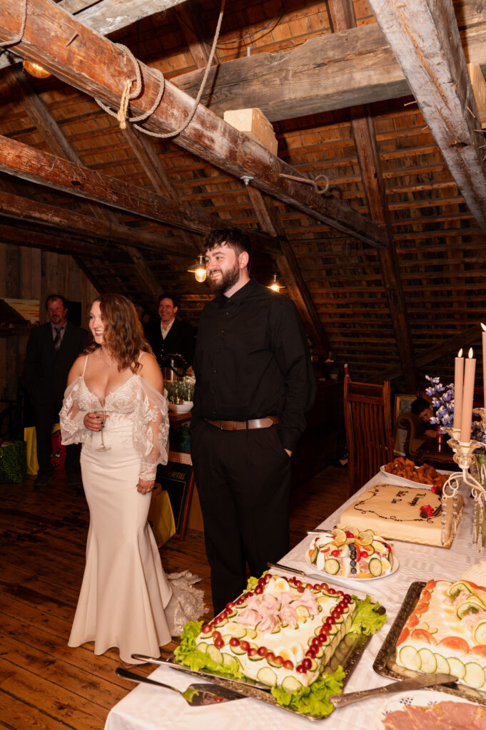 The bride and groom receiving well wishes during their destination wedding reception at an Airbnb in Ísafjörður.